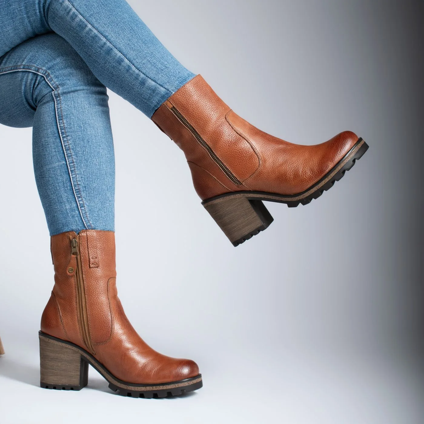 Brown ankle boots worn with fitted jeans